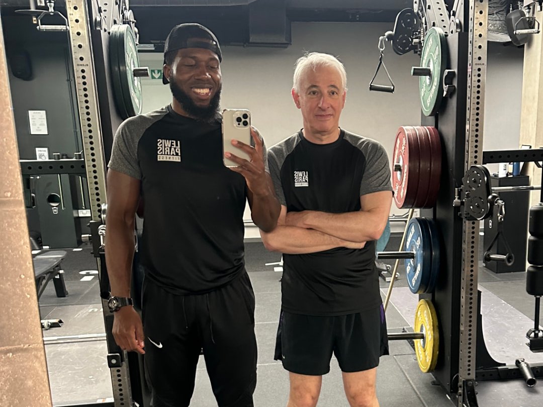 A client with Lewis Paris in the gym