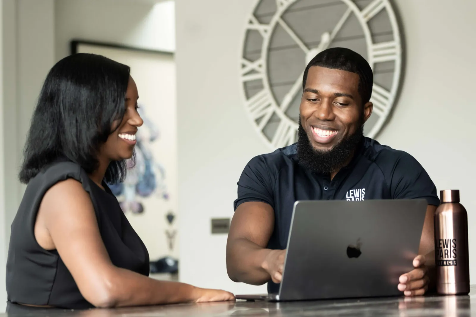 Lewis Paris talking through a training plan with a female client